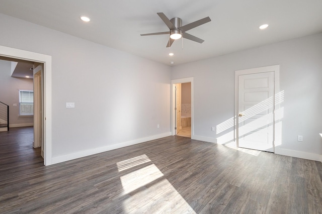 unfurnished room with ceiling fan and dark wood-type flooring