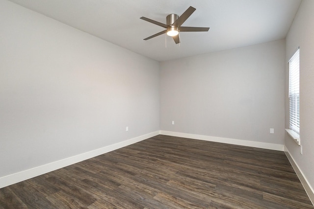 spare room featuring dark hardwood / wood-style flooring and ceiling fan