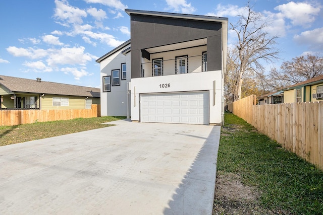 view of front of home with a balcony and a garage