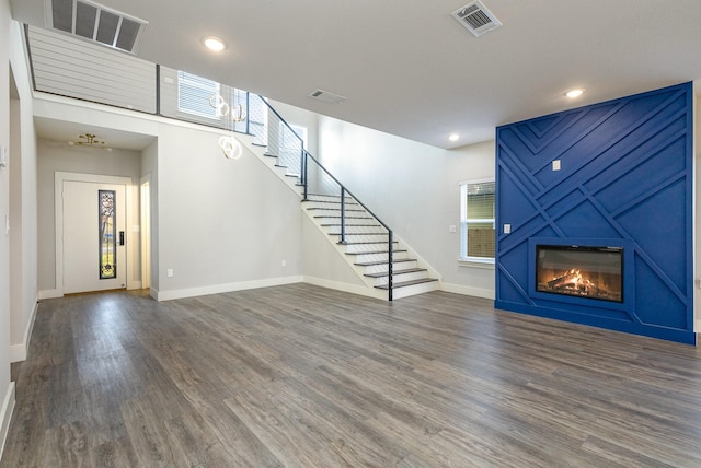 unfurnished living room with dark hardwood / wood-style flooring