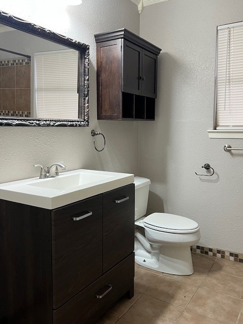 bathroom featuring vanity, tile patterned floors, and toilet