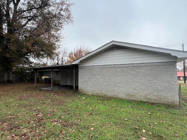 view of side of property with a yard