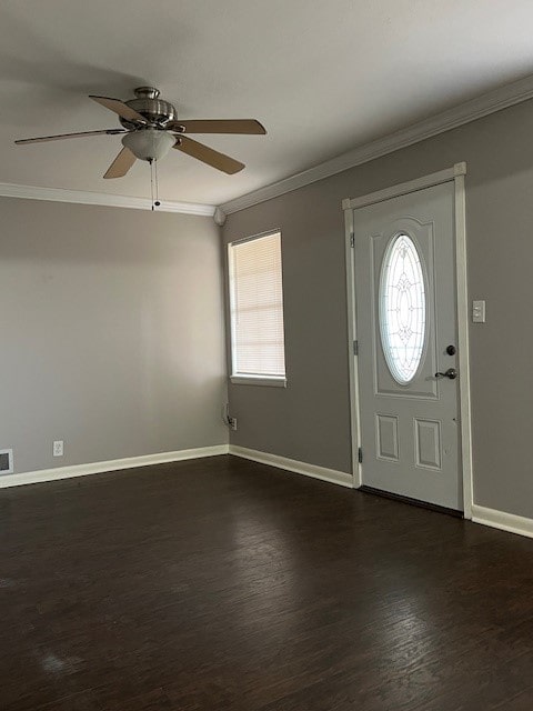 entrance foyer featuring a wealth of natural light, dark hardwood / wood-style floors, and ornamental molding