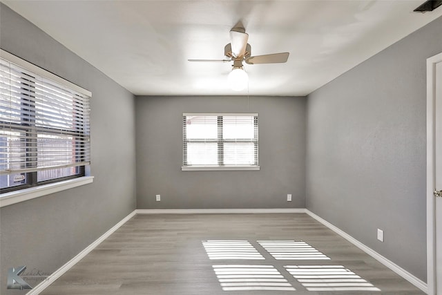 empty room featuring light wood-type flooring and ceiling fan