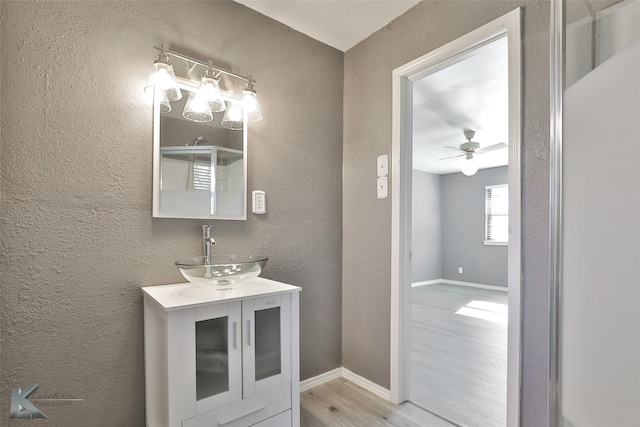 bathroom featuring vanity, ceiling fan, and wood-type flooring