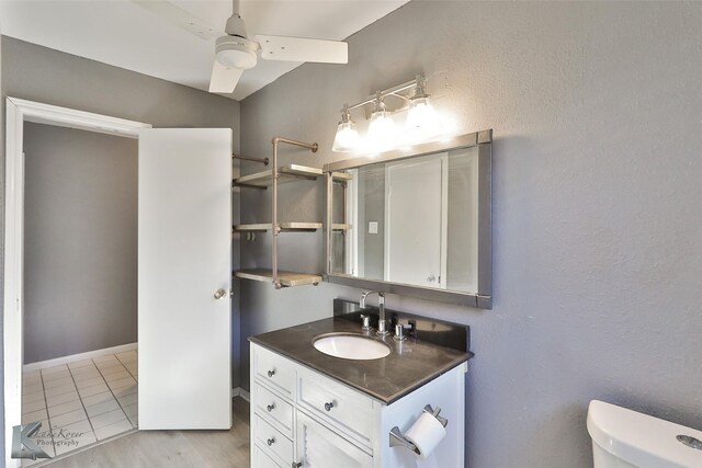 bathroom featuring tile patterned floors, ceiling fan, vanity, and toilet