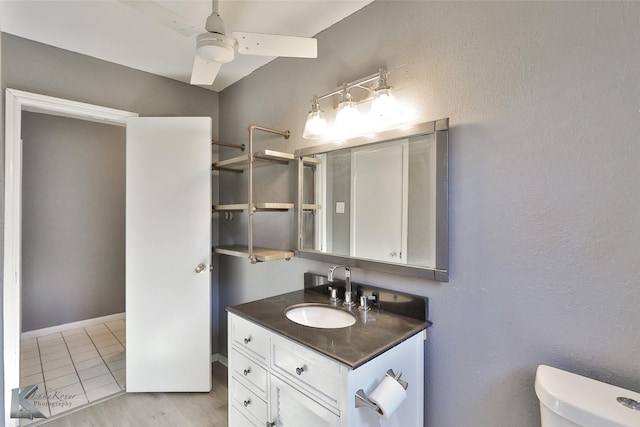 bathroom with ceiling fan, vanity, and toilet