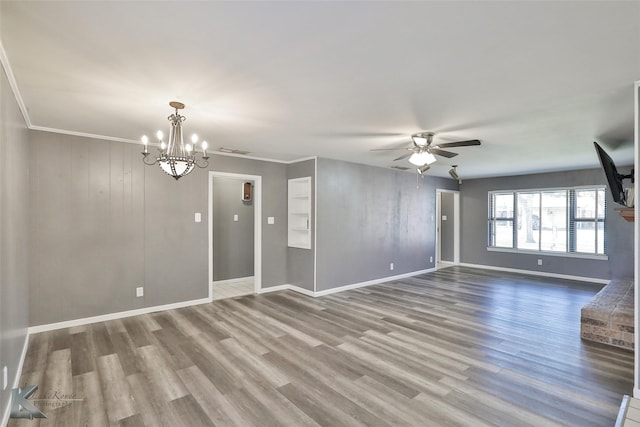 unfurnished room with hardwood / wood-style floors, ceiling fan with notable chandelier, and crown molding