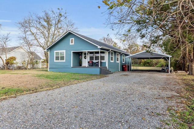 view of front of house with a carport and a front lawn