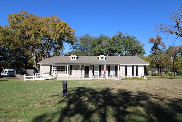 ranch-style home featuring a porch and a front lawn