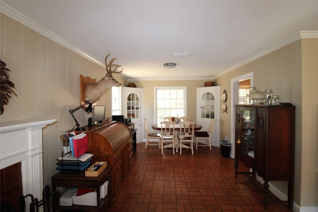 dining room featuring wooden walls and ornamental molding