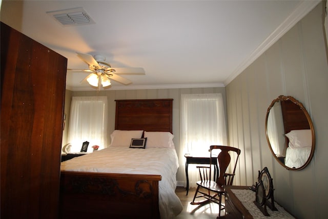 bedroom featuring ceiling fan and crown molding