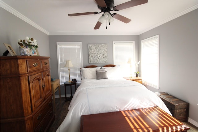 bedroom featuring ceiling fan, dark hardwood / wood-style flooring, and crown molding