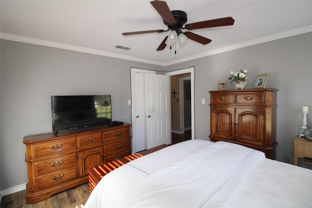 bedroom with ceiling fan, crown molding, and dark wood-type flooring