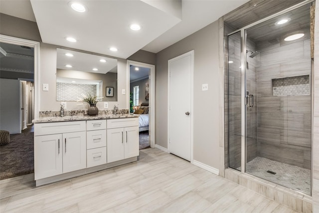 bathroom with vanity and a shower with door