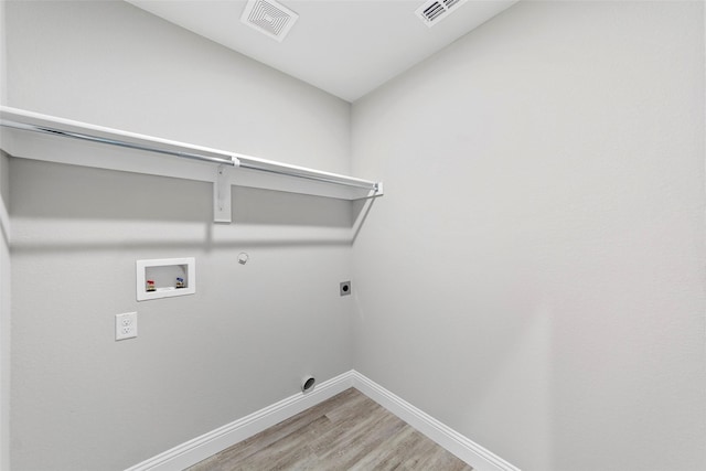 laundry room featuring hookup for an electric dryer, wood-type flooring, hookup for a washing machine, and hookup for a gas dryer