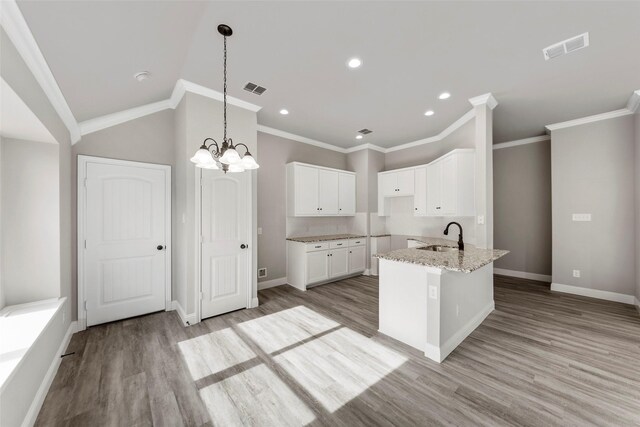 kitchen featuring white cabinetry, light stone countertops, sink, light hardwood / wood-style flooring, and crown molding