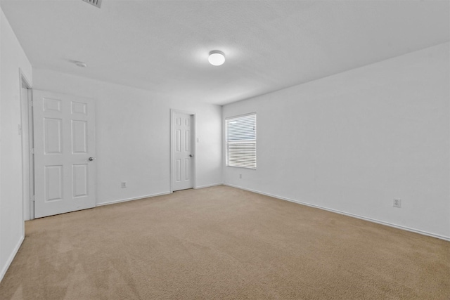 unfurnished room featuring light colored carpet