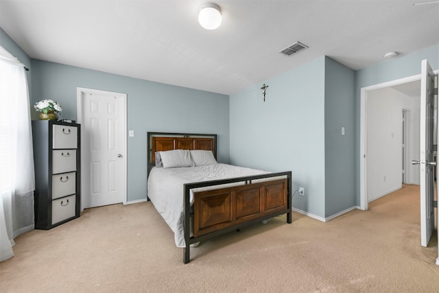 bedroom featuring light colored carpet