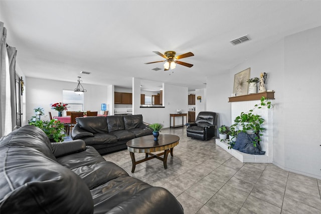 living room with ceiling fan and a brick fireplace