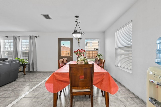 dining space featuring light tile patterned floors and plenty of natural light