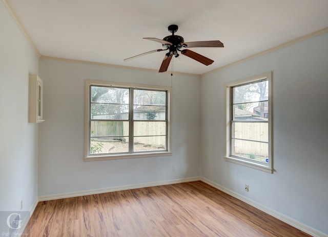 empty room featuring ceiling fan, ornamental molding, and light wood-type flooring