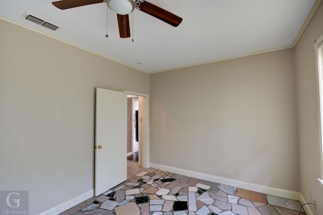 spare room featuring ceiling fan and ornamental molding