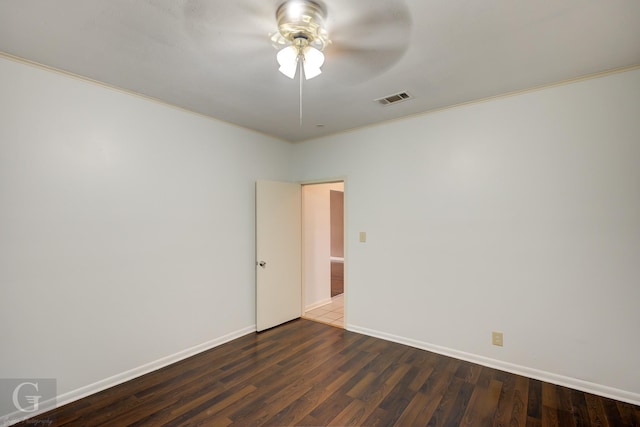 empty room with crown molding, ceiling fan, and dark hardwood / wood-style floors