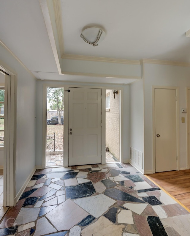 foyer with crown molding and light hardwood / wood-style flooring