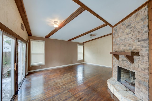 unfurnished living room featuring dark hardwood / wood-style floors, lofted ceiling with beams, and a fireplace