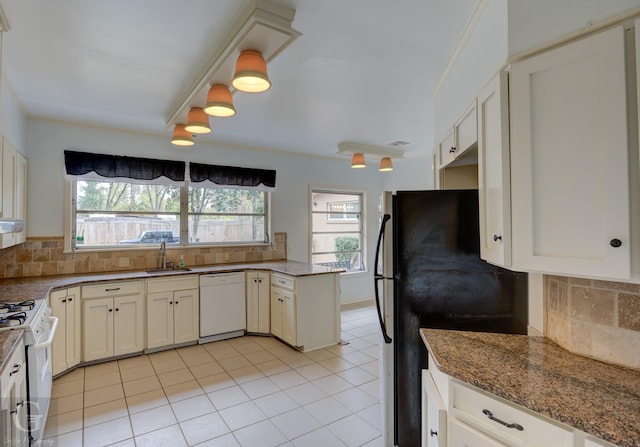 kitchen featuring white cabinets, decorative backsplash, white appliances, and sink