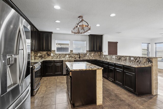 14849 Ledgeview Ct, Balch Springs, TX 75180 - kitchen featuring stainless steel appliances, plenty of natural light, light stone countertops, a sink, and recessed lighting