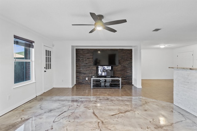 unfurnished living room with a textured ceiling, ceiling fan, and crown molding