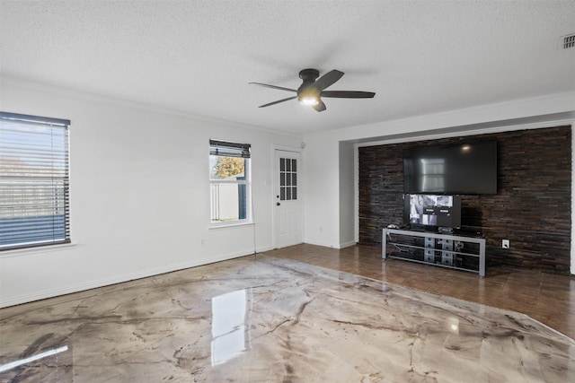 unfurnished living room with ceiling fan, a textured ceiling, and ornamental molding