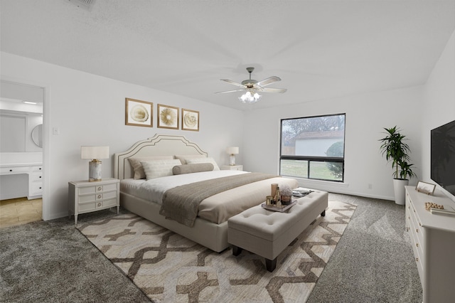 bedroom featuring carpet, ceiling fan, and ensuite bath