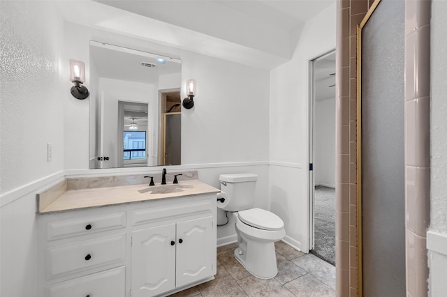 bathroom featuring vanity, tile patterned flooring, and toilet