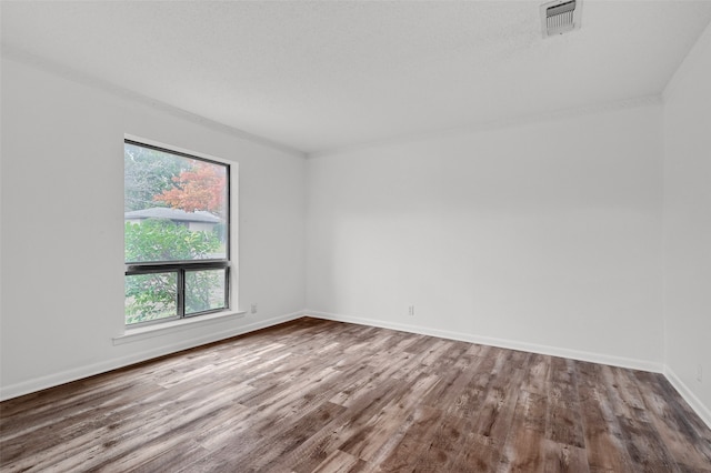 spare room with hardwood / wood-style floors