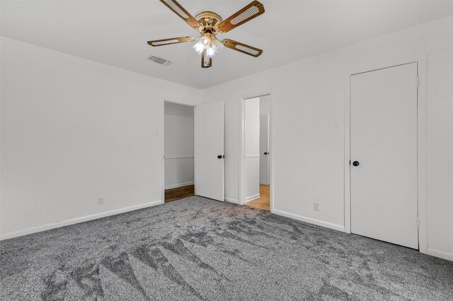 unfurnished bedroom with ceiling fan and carpet