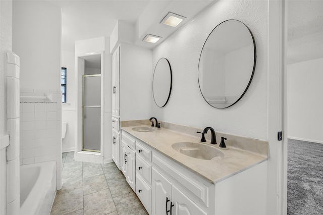 bathroom featuring vanity, shower with separate bathtub, and tile patterned flooring