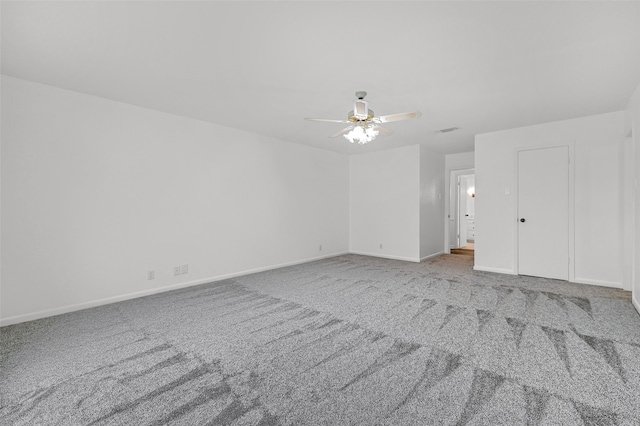 unfurnished room with ceiling fan and carpet