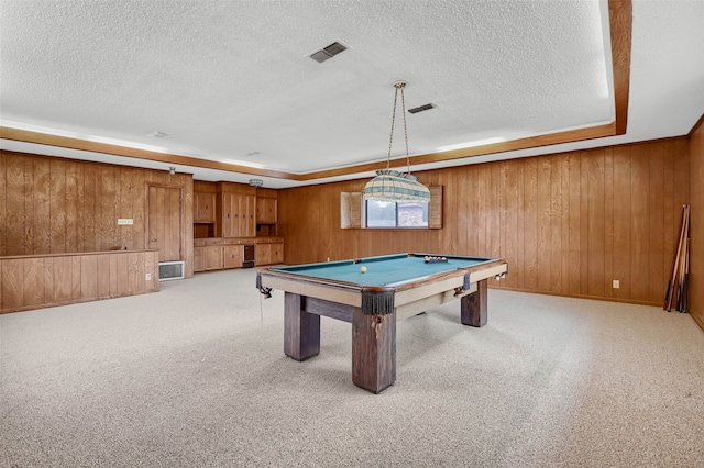 recreation room featuring light colored carpet, wooden walls, billiards, and a textured ceiling