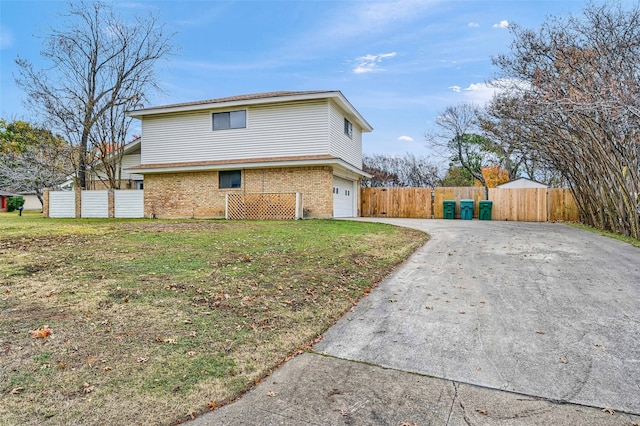 view of side of home with a garage and a yard