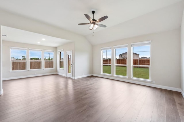 unfurnished room with lofted ceiling, hardwood / wood-style floors, and ceiling fan