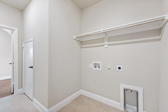 clothes washing area with hookup for a washing machine, gas dryer hookup, and electric dryer hookup