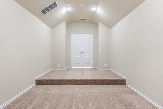 interior space featuring carpet floors and lofted ceiling