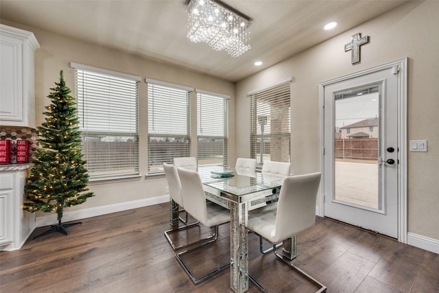 dining space featuring dark hardwood / wood-style flooring and an inviting chandelier