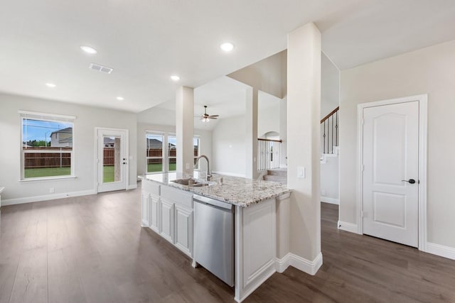 kitchen with sink, white cabinetry, dark hardwood / wood-style flooring, dishwasher, and light stone countertops