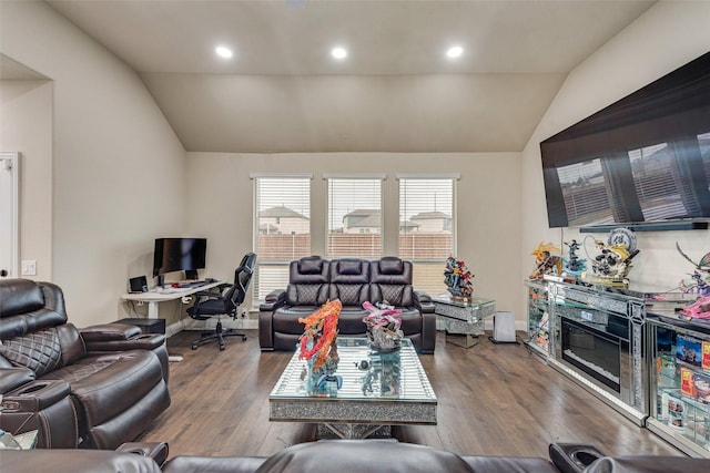 living room featuring light hardwood / wood-style floors and vaulted ceiling