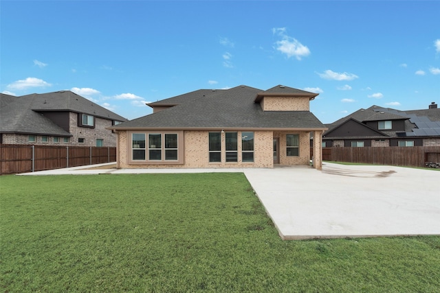 rear view of property featuring a yard and a patio