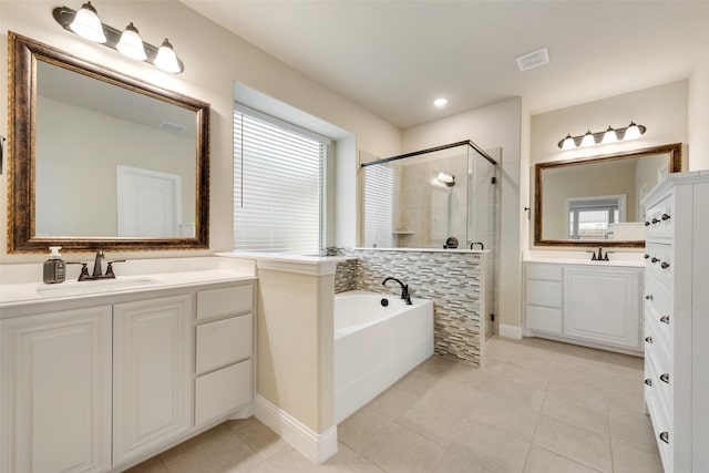 bathroom with tile patterned floors, vanity, and separate shower and tub